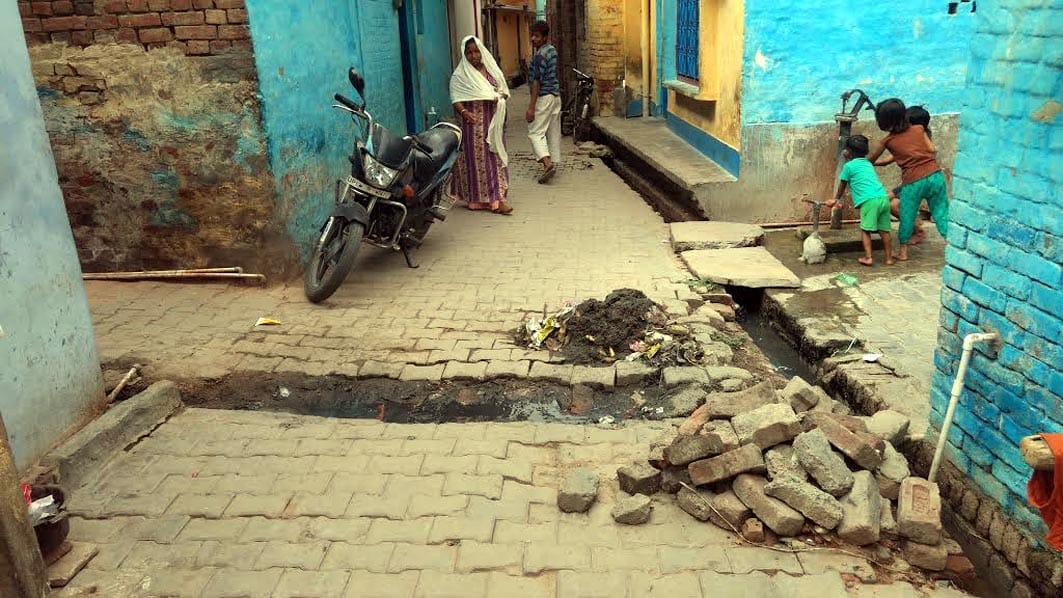 Shabby street, people get upset with a pile of dirt
