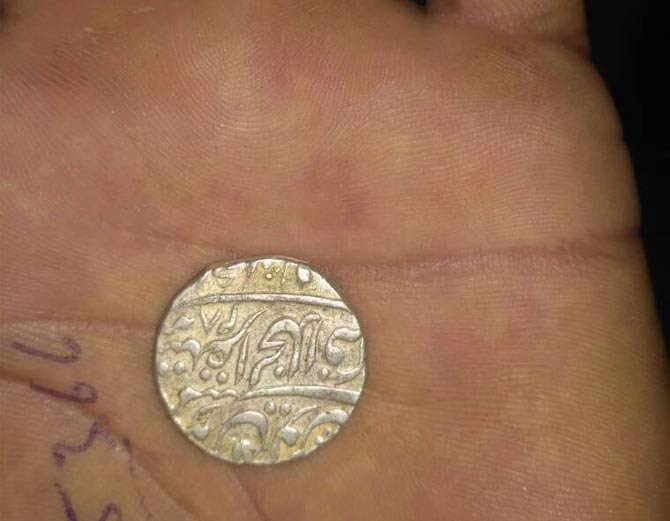pitcher full of antique coins of silver coins found in excavations of farm at rewari