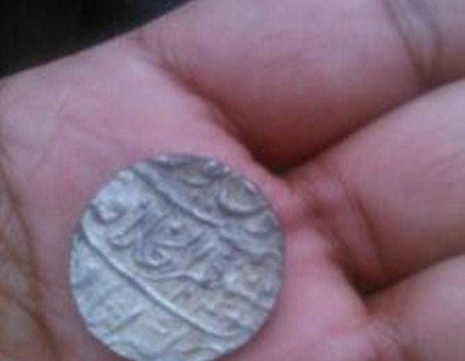 pitcher full of antique coins of silver coins found in excavations of farm at rewari