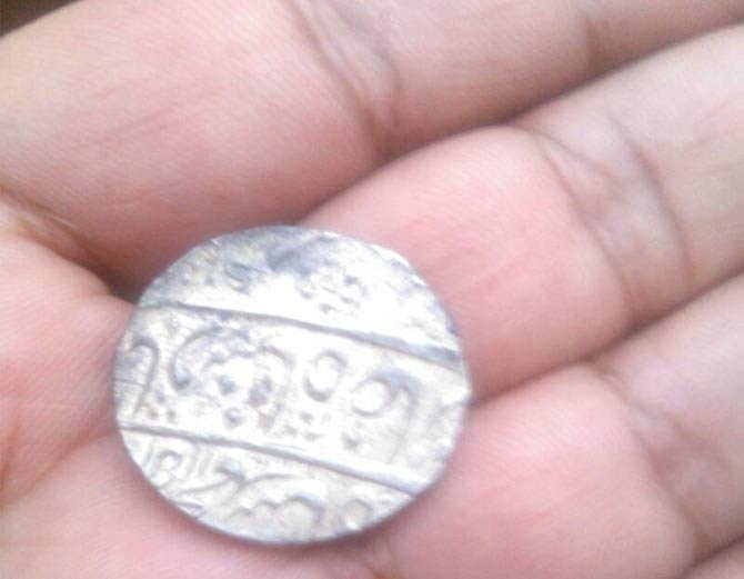 pitcher full of antique coins of silver coins found in excavations of farm at rewari