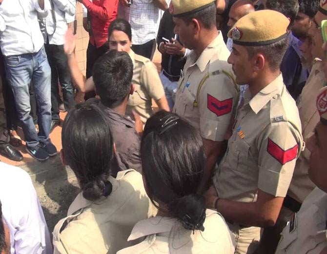 boy was capturing video of girls, brutally beaten by lady police on road at kaithal