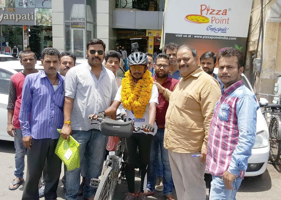 This person is giving a message of save the environment by bicycle 