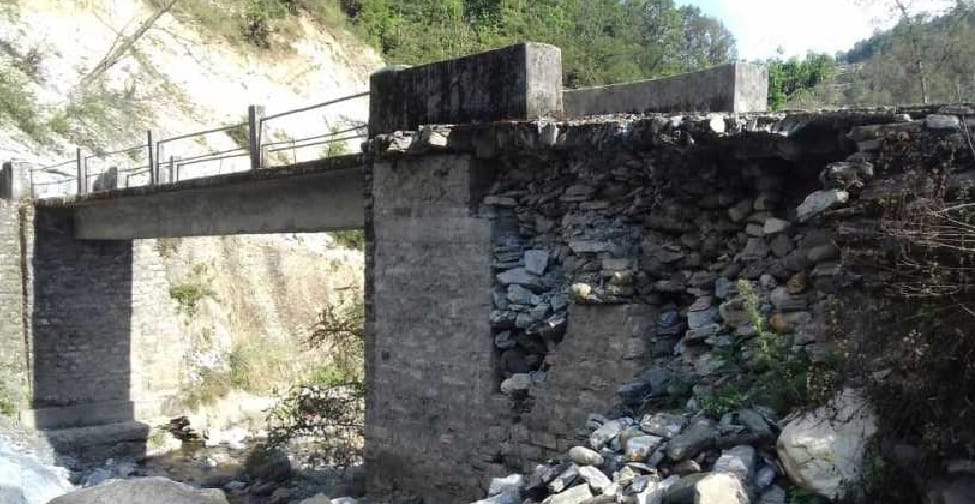 Damaged wall of bridge over not built even after a year