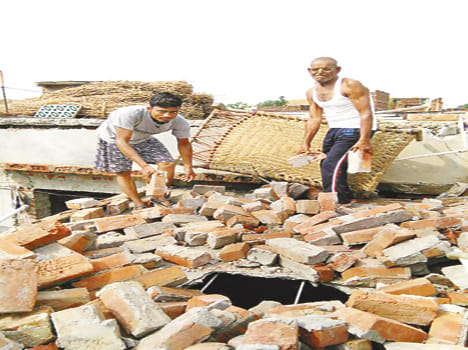 Tornado sheds in rainstorm, 12 people injured in wall collapse