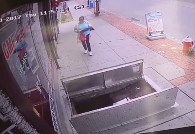 woman, 67, distracted by her phone plunged in to an open sidewalk door