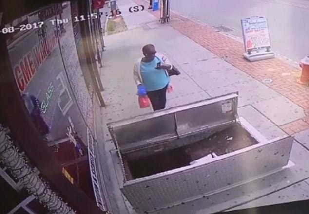 woman, 67, distracted by her phone plunged in to an open sidewalk door