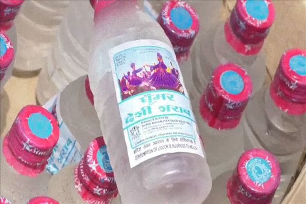 Woman selling illegal alcohol in tea stall
