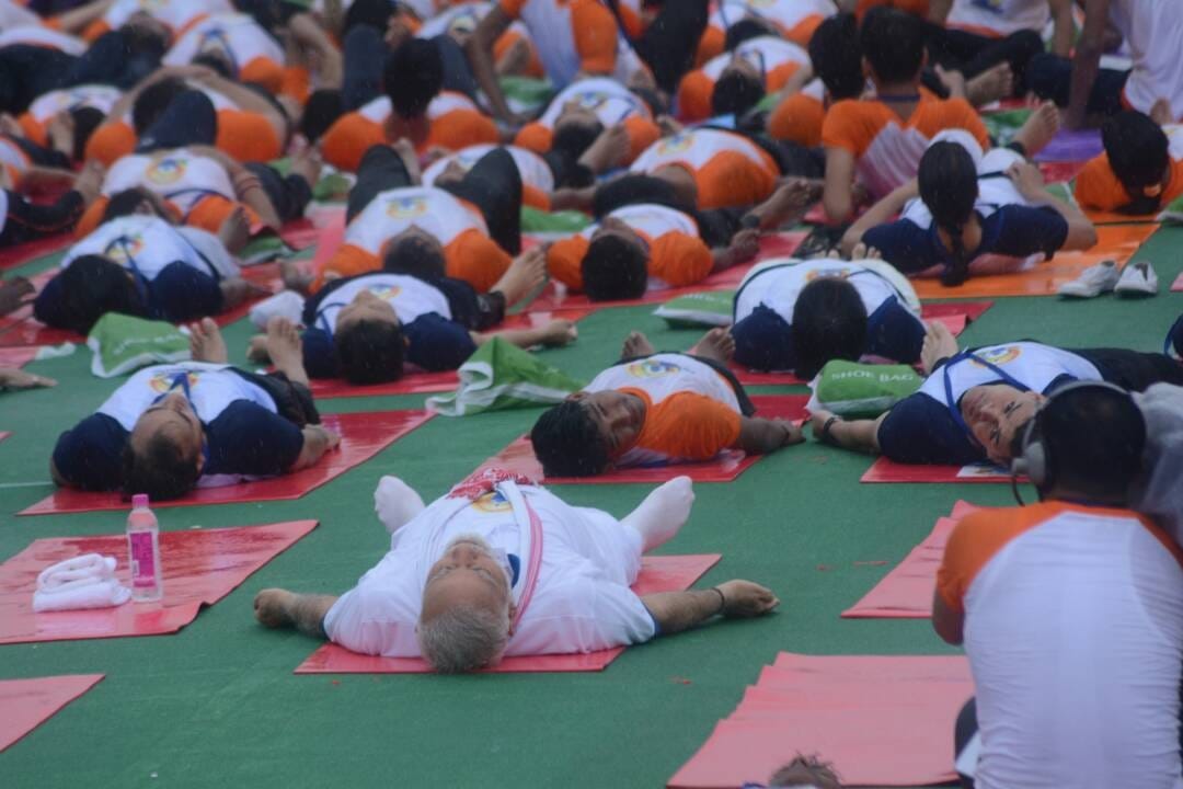people perform yoga in Lucknow with prime minister Modi.