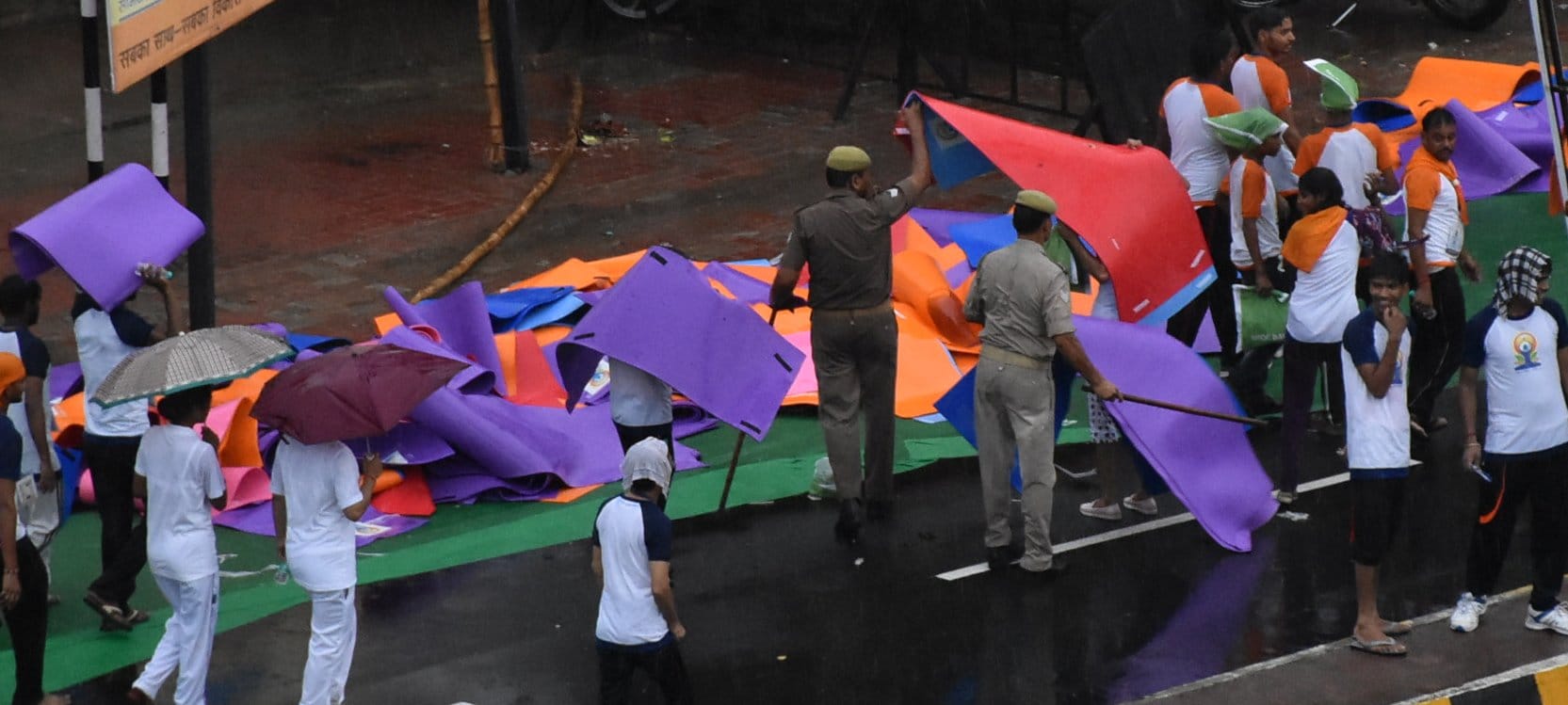  People take away mats after doing Yoga.