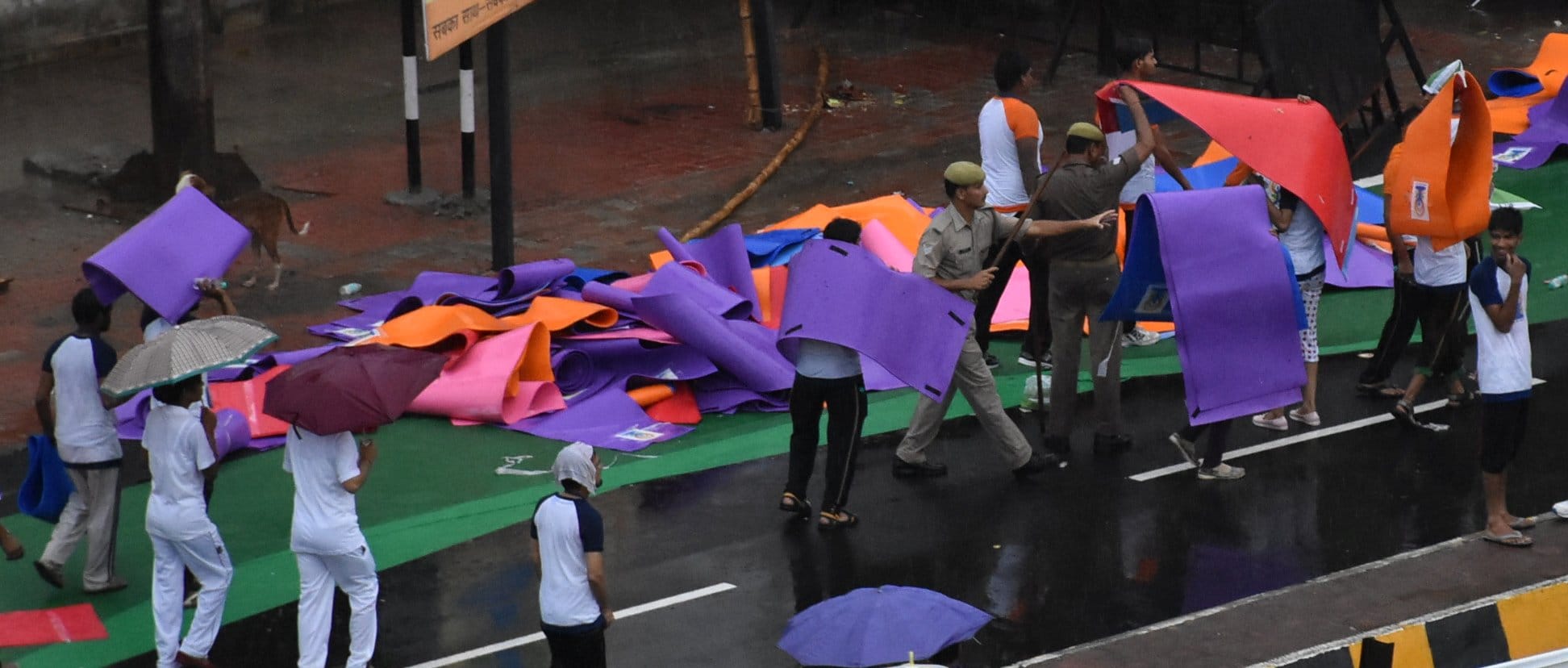 People take away mats after doing Yoga.