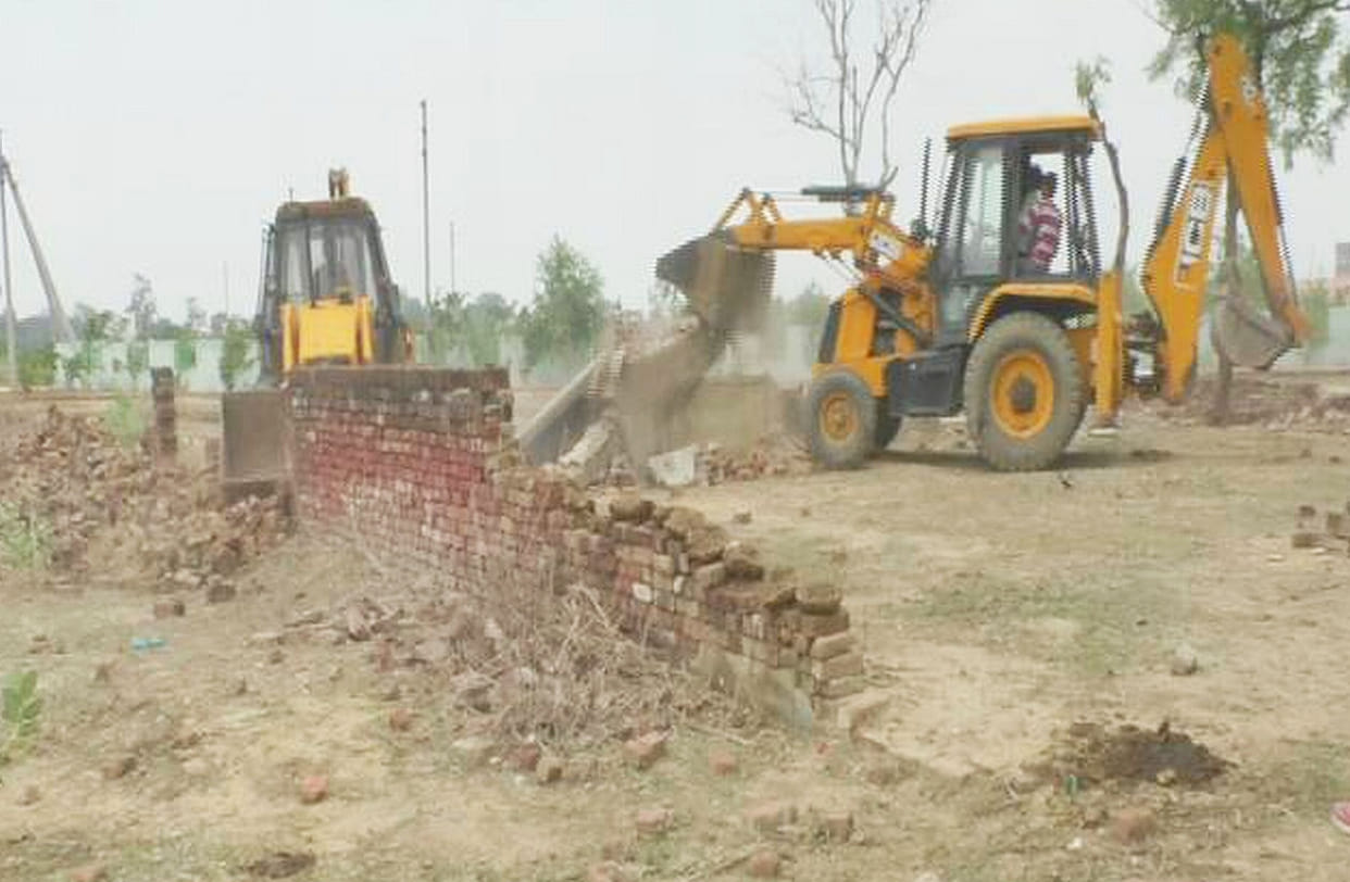 Bulldozers run on old houses and godowns.