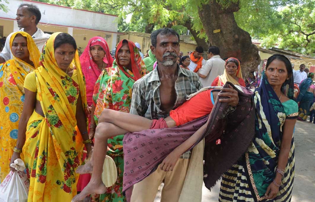 tribal father lifted his ill son in the lap and  reached the DM office