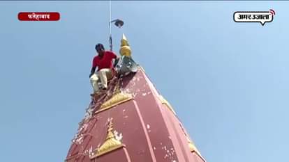 women climbing up to 50 feet high temple mount in fatehabad 