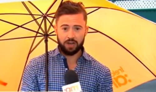 Reporter Deric O hartagain blown by the wind during live telecast of weather reoprt in Dublin
