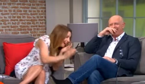 Reporter Deric O hartagain blown by the wind during live telecast of weather reoprt in Dublin