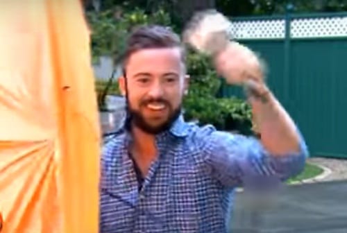 Reporter Deric O hartagain blown by the wind during live telecast of weather reoprt in Dublin