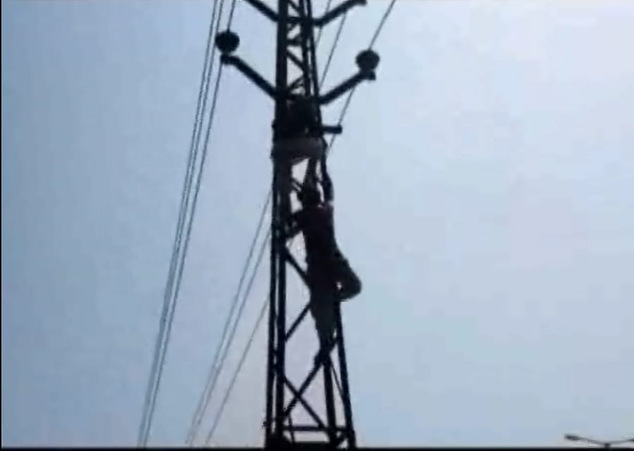 son scolded by his father climbed on high tension line pillar 