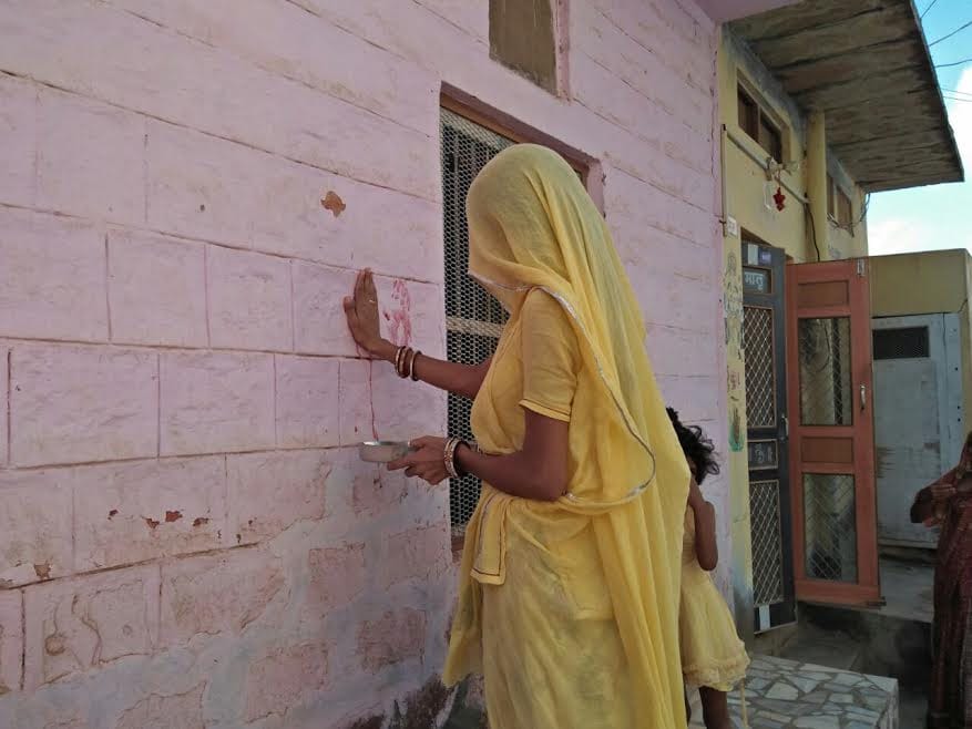 Swastiks are being made at the door of the house