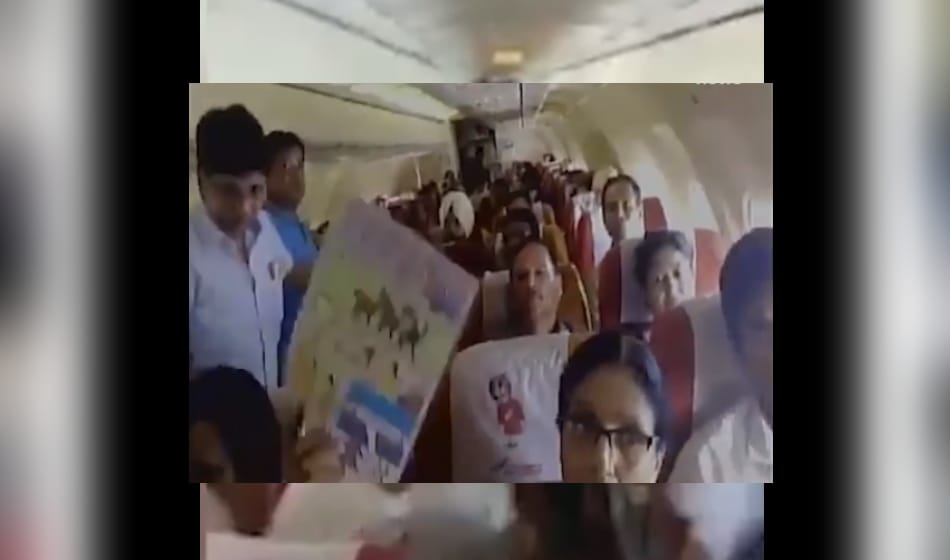 after ac malfunction on air india flight from bagdogra to delhi passengers use paper fan for relief