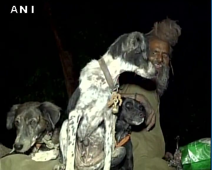 Sadhu Dula Nath along with his dogs travels to religious places on a bike