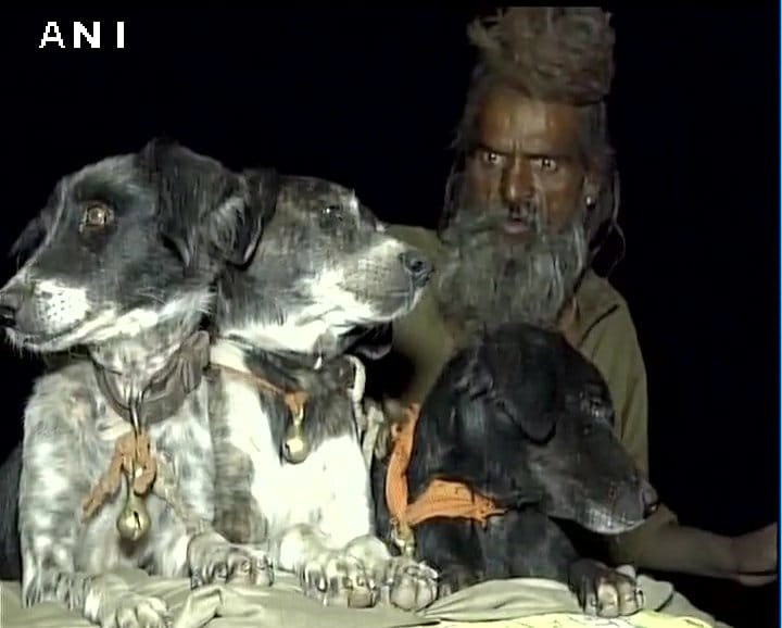 Sadhu Dula Nath along with his dogs travels to religious places on a bike