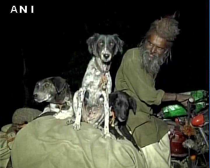 Sadhu Dula Nath along with his dogs travels to religious places on a bike