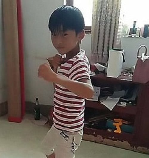 Chinese man gives hillarious demonstration of pantyhose tights by stuffing his son in it