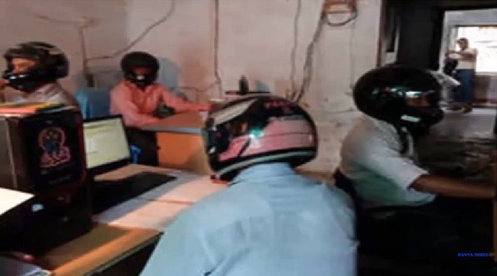 Employee at land records department in East   Champaran district of Bihar working wearing   helmet