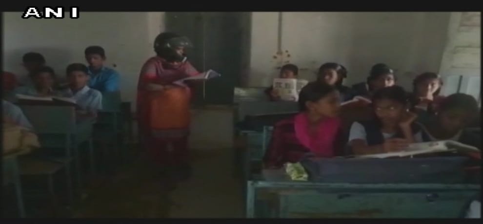 in Telangana, teachers wear helmets as protest against delay in renovation of school building