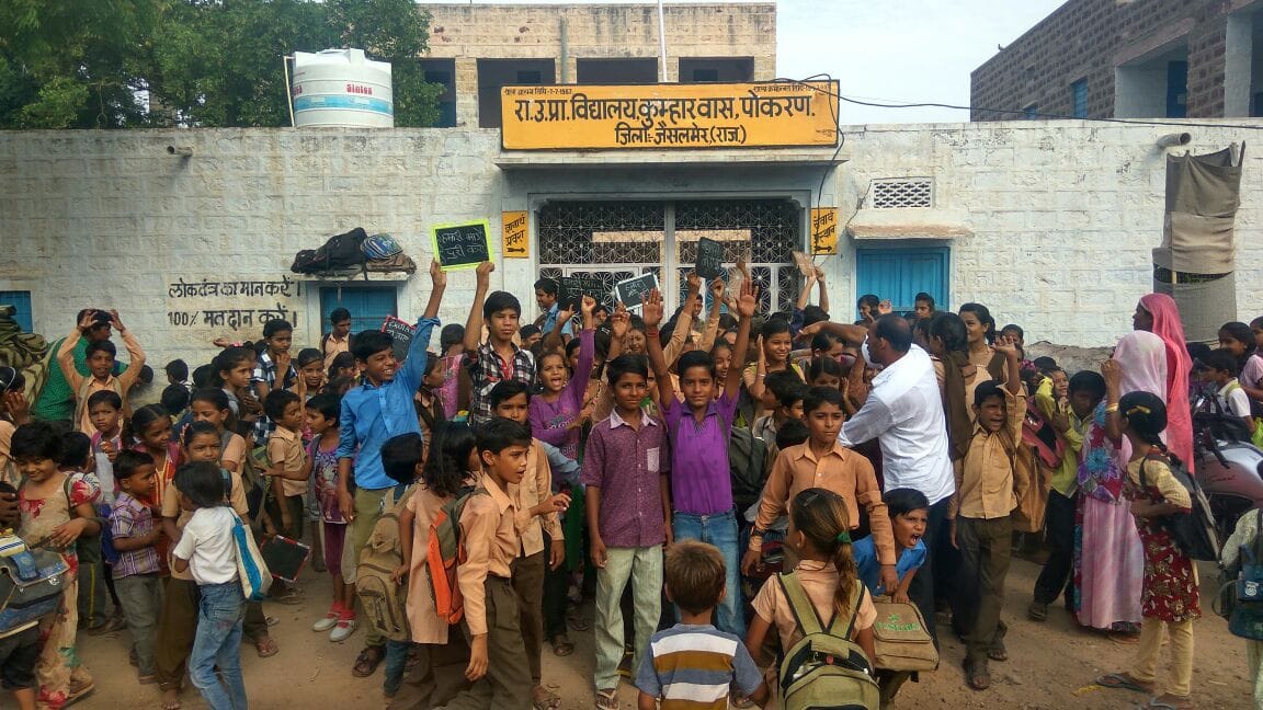 A teacher is teaching hundreds of children