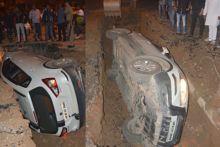 pics of a car falls down in a pit in lucknow 