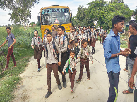 Villagers walk on the road to cow's death