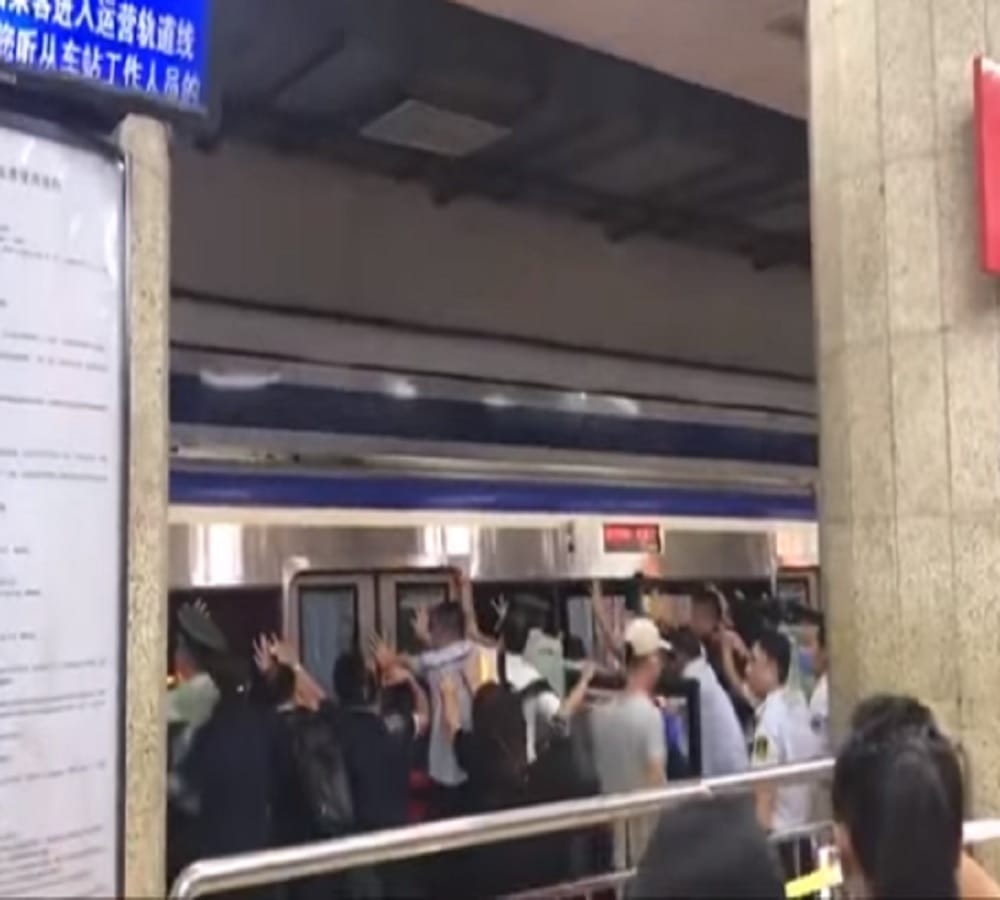 watch Viral Video of people pushing metro to rescue man stuck in platform gap in China