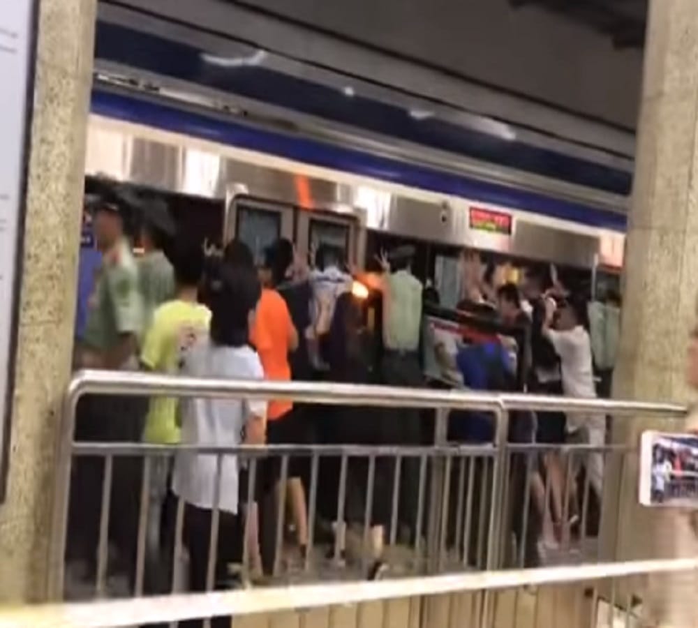 watch Viral Video of people pushing metro to rescue man stuck in platform gap in China