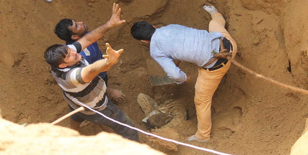 Two laborers buried by the collapse of soil, dead body after hard cocktail