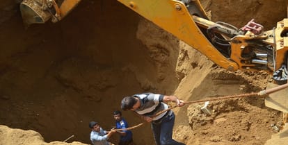Two laborers buried by the collapse of soil, dead body after hard cocktail
