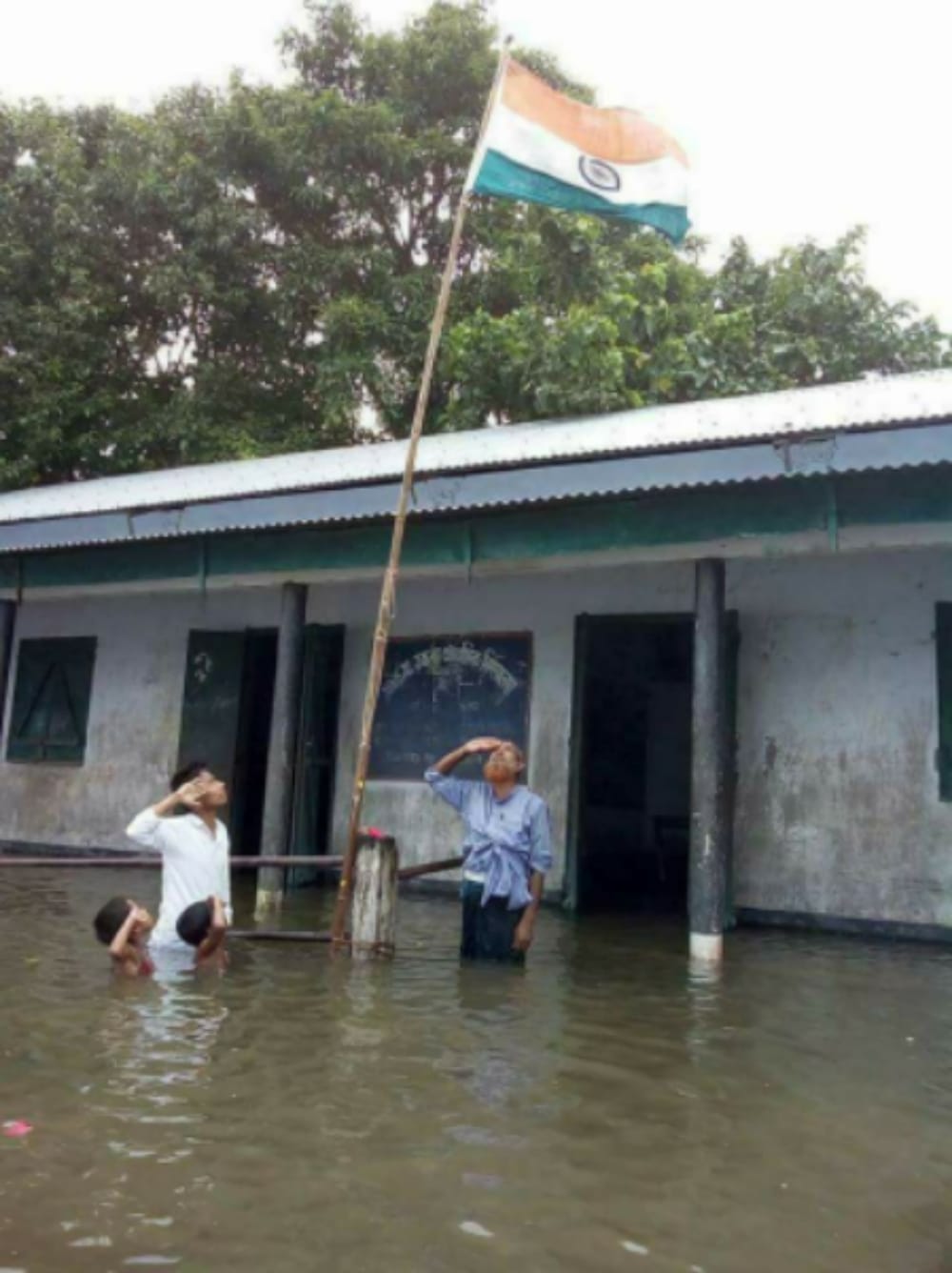 Assam schoolkids saluting the national flag by sinking into the water, photo viral