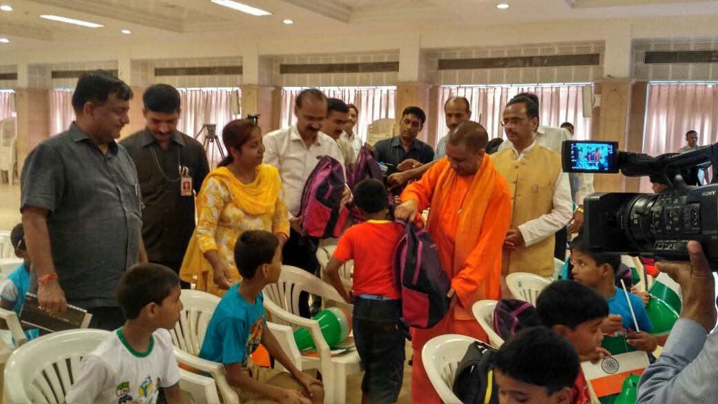 up cm yogi distributes books to orphan children