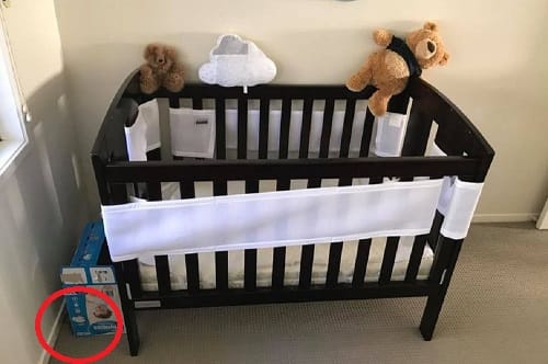 Spot the snake crawling near baby cot in this picture