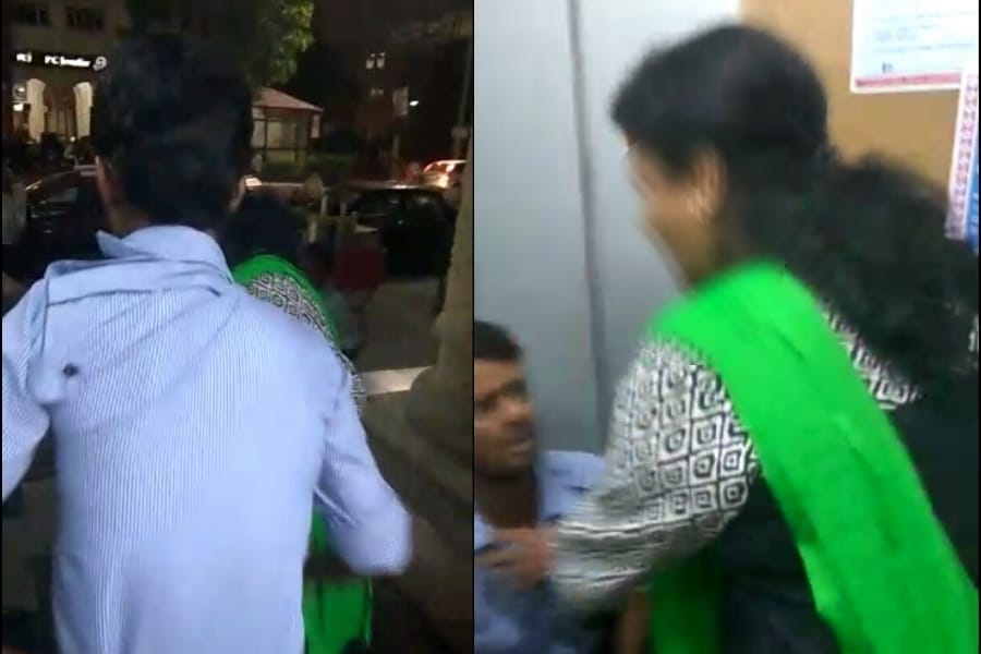Women beats an ATM guard for making their videos.