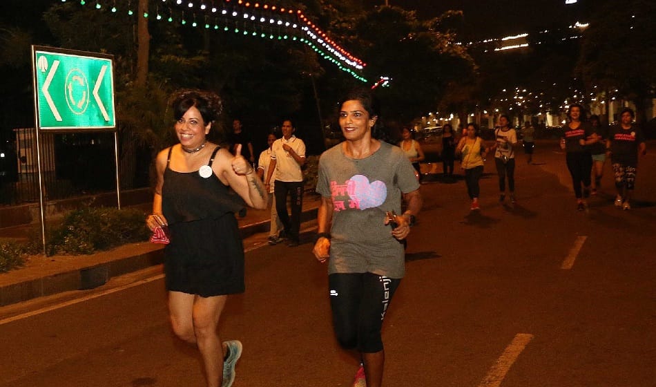 women running on road in cannought place in midnight