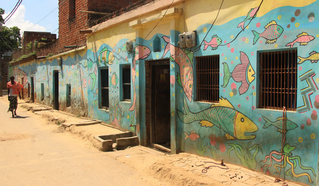 see the photos of varanasi village house fish painting