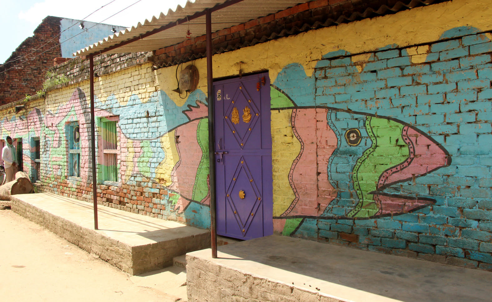 see the photos of varanasi village house fish painting