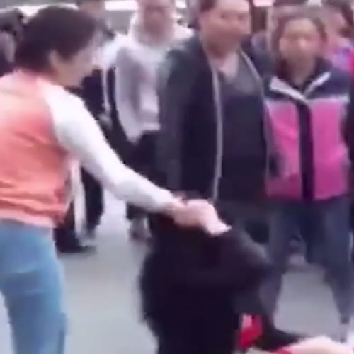 a women beaten by wife of the man in China street