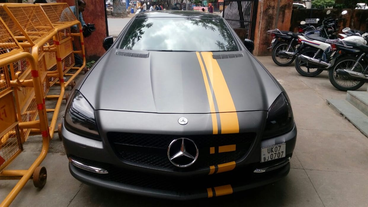 A car caught in the night, the crowd of people watching in the police station