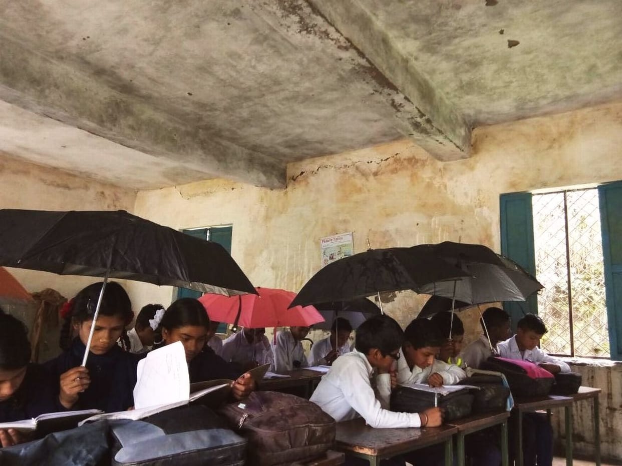 student attending class with umbrella