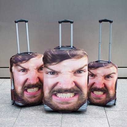 Face Luggage covers by Firebox will help you recognize you suitcase and travel bags