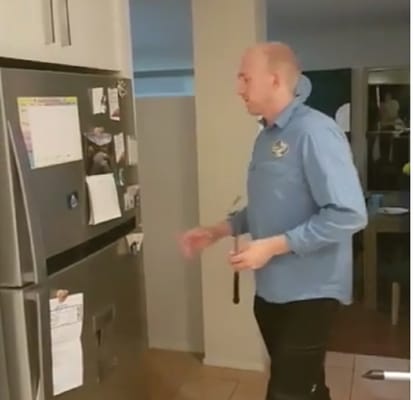 Watch video Man Pulls Out Python Hiding In Fridge