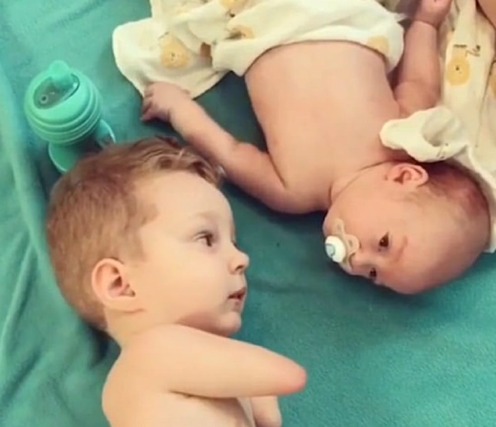  Camden born without hands or legs calms his baby brother crying by giving him a pacifier