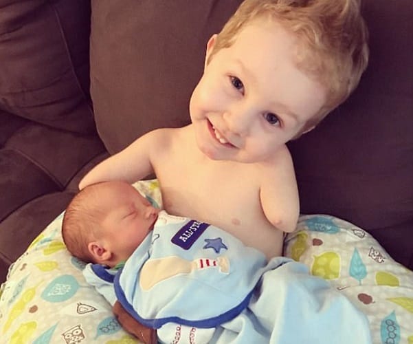  Camden born without hands or legs calms his baby brother crying by giving him a pacifier